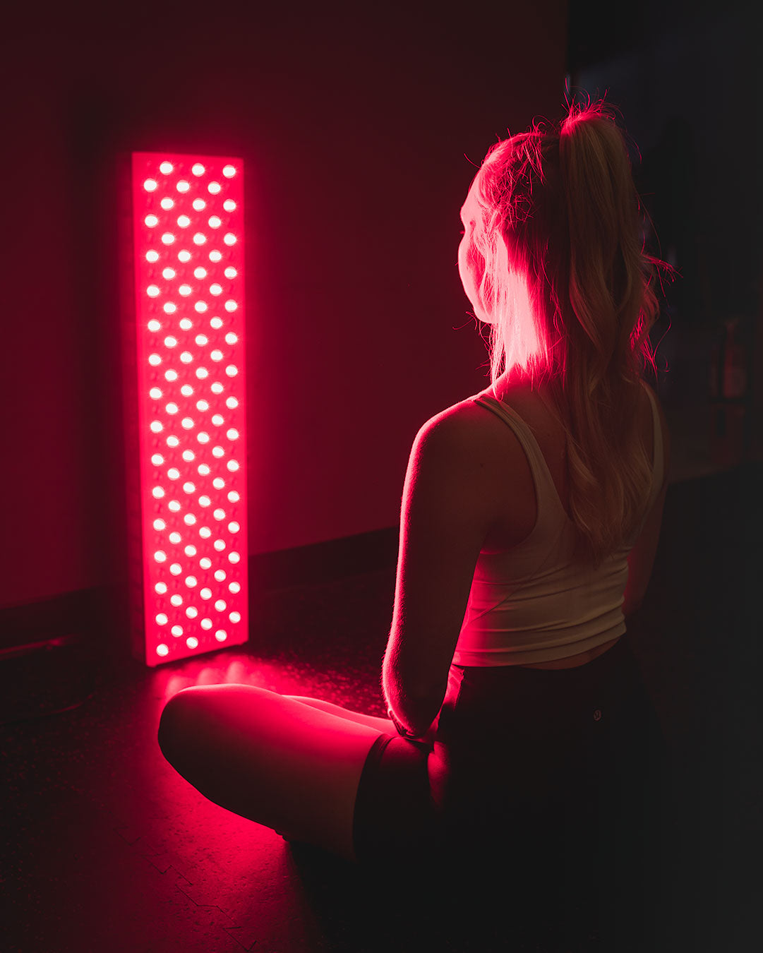 Orion Red Light Therapy - woman sitting in front of the Orion Pro 900